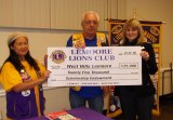 Lemoore Lions President Ever Casas and Treasurer Bill Mayer present a check for $25,000 to West Hills Lemoore President Kristin Clark. The check is a culmination of 4 years of donations to the college.